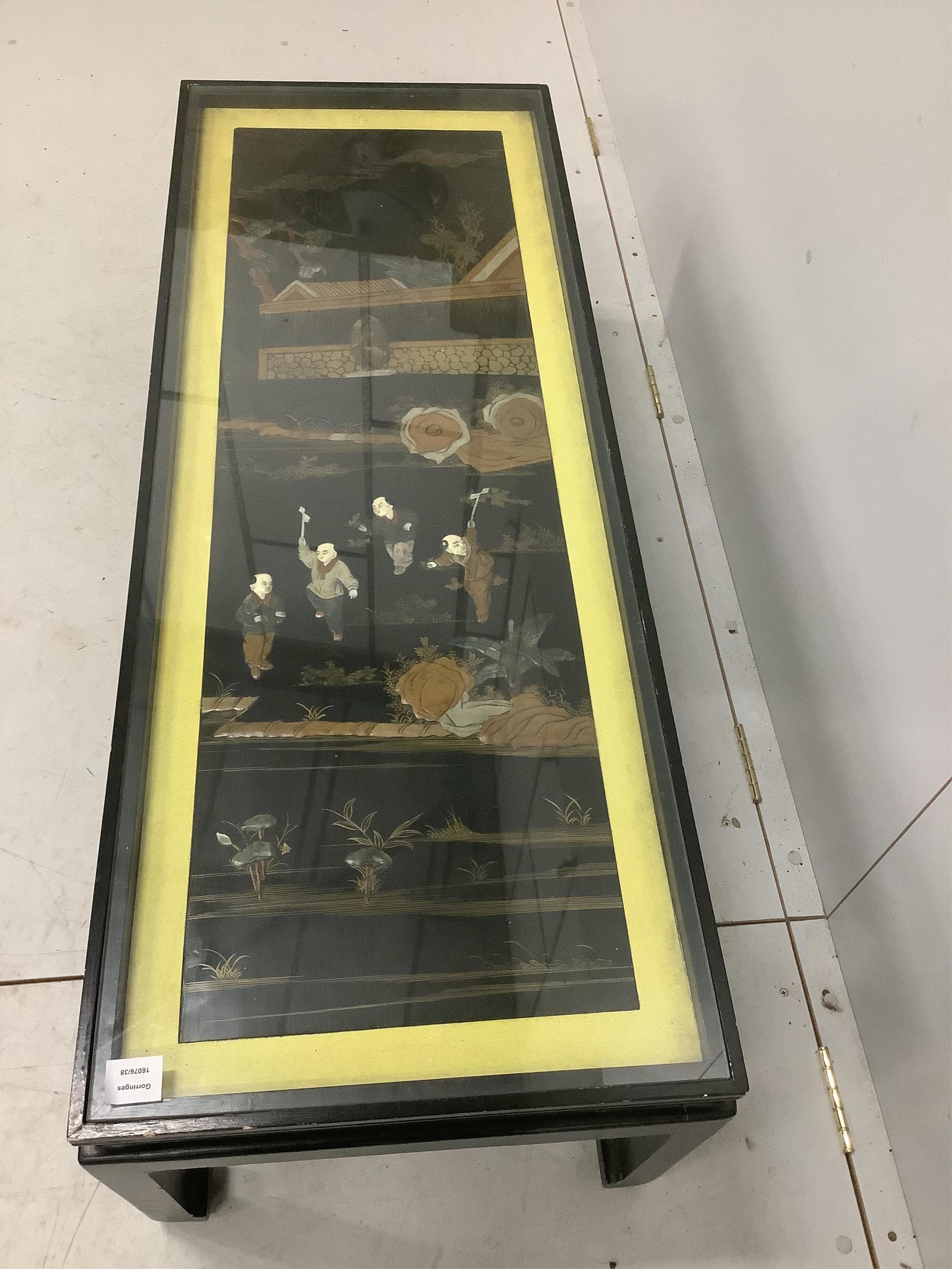 A Chinese ebonised table inset with a soapstone panel, width 132cm, depth 50cm, height 41cm. Condition - fair